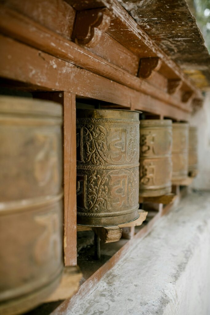 Rustic Buddhist prayer wheels at a monastery in Leh, India.